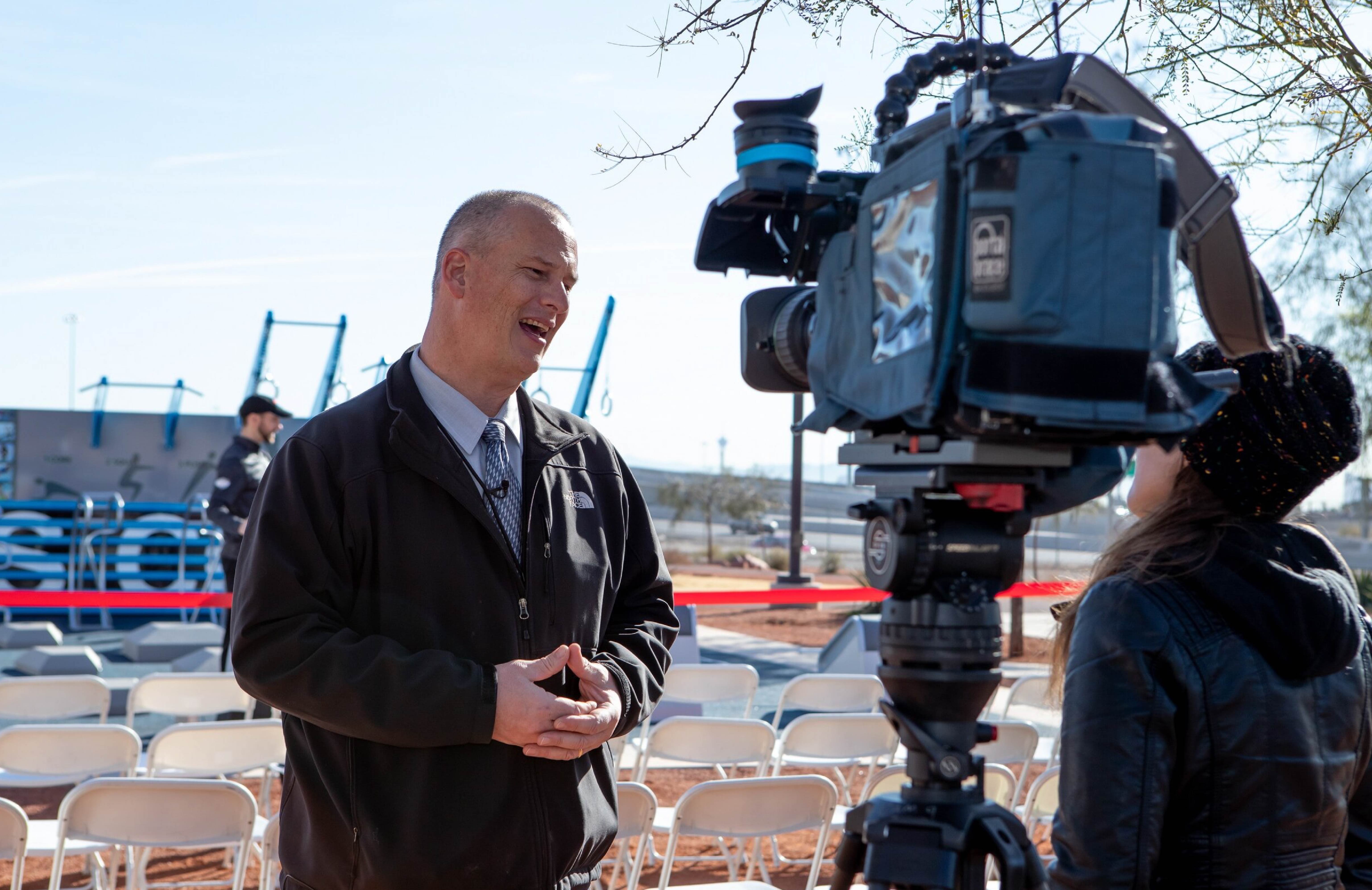 civic leader being interviewed by TV news crew on Fitness Court