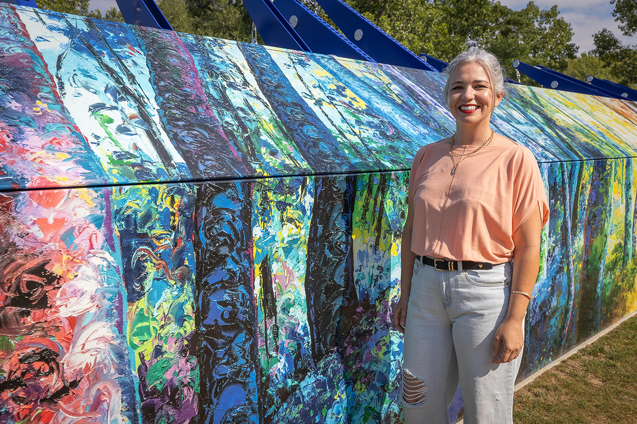 Local Artist in front of outdoor gym with their public art