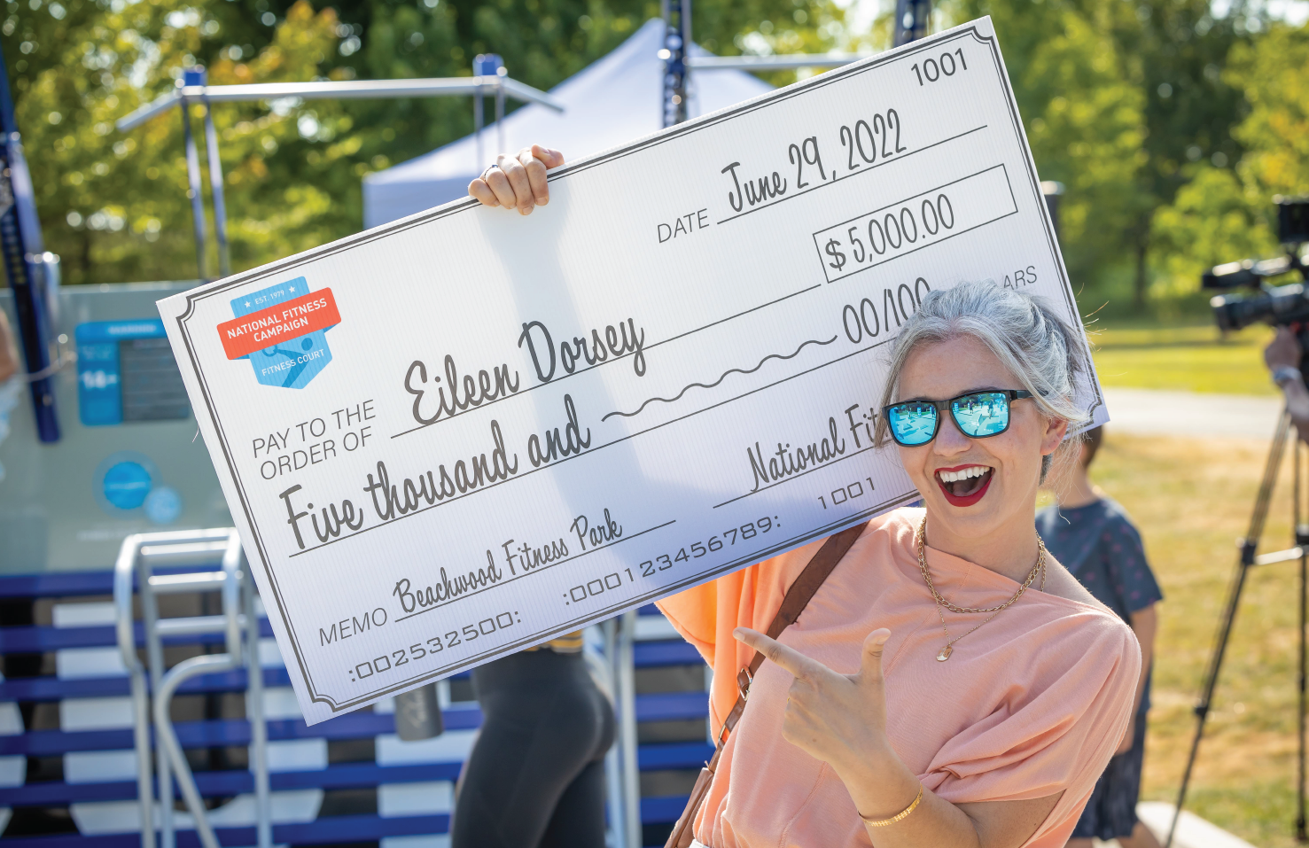 artist holding check on Fitness Court