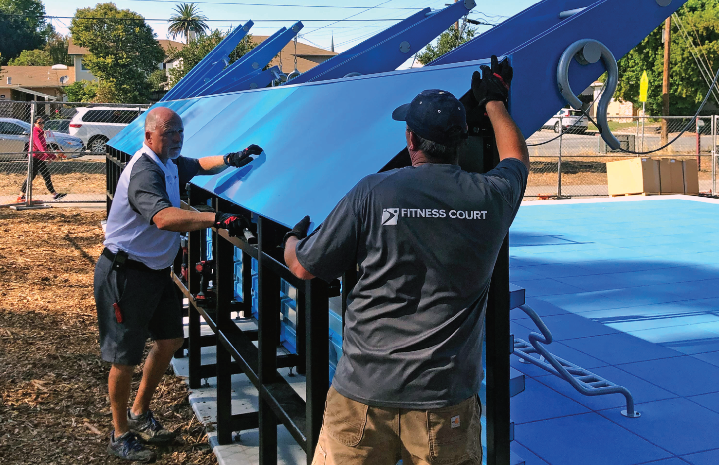 two gentleman shown installing a Fitness Court