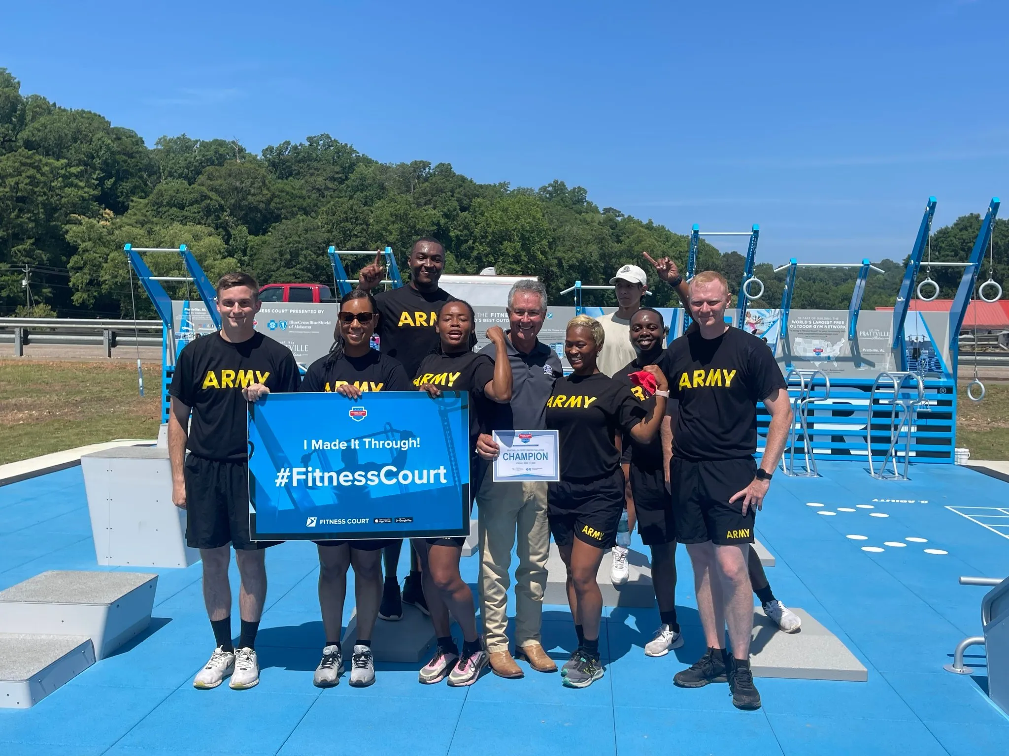 group of Army veterans holding signs completing the Fitness Court challenge
